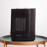 بخاری سرامیکی برقی روی میز کنار تخت خواب